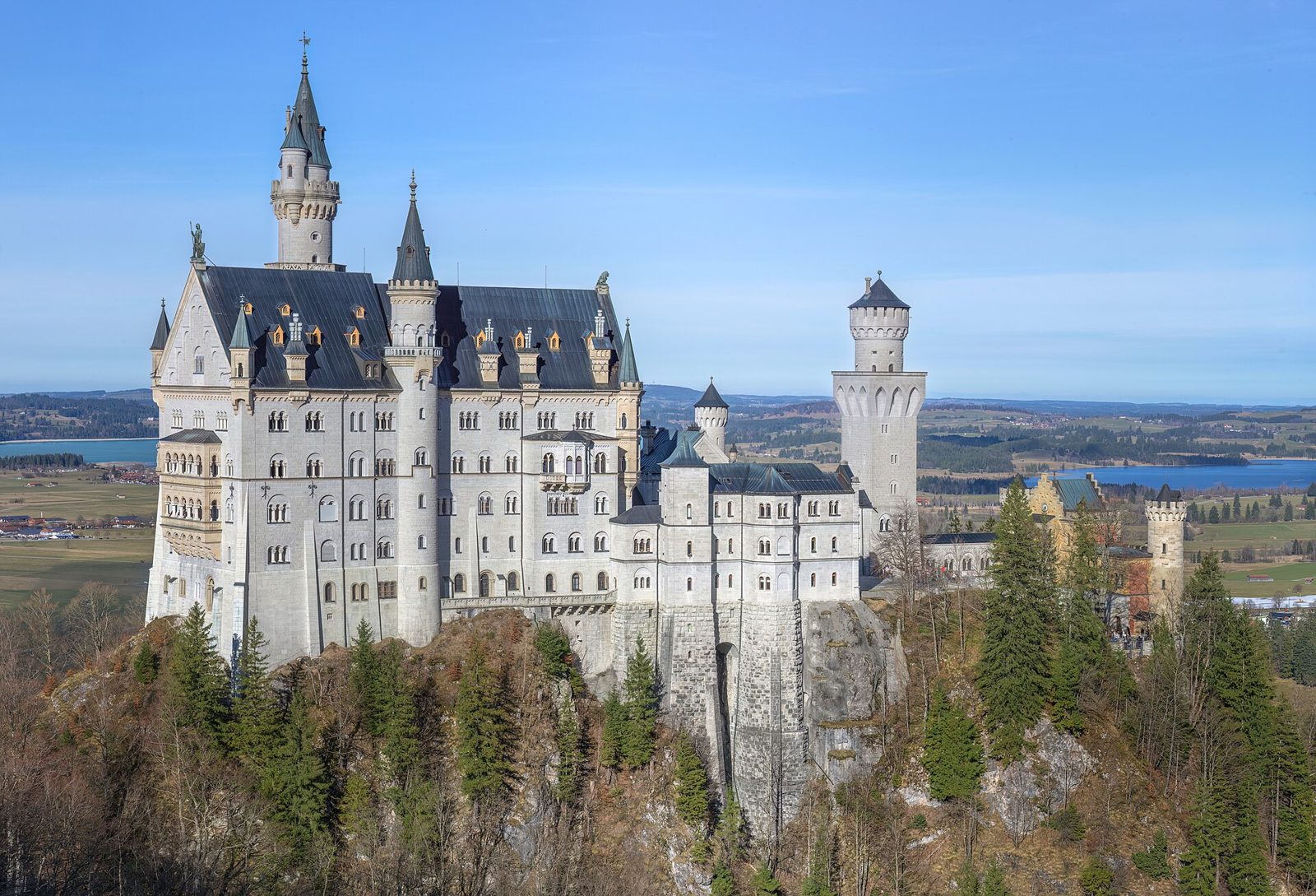 Neuschwanstein Castle in Bavaria, its white towers rising from wooded hills