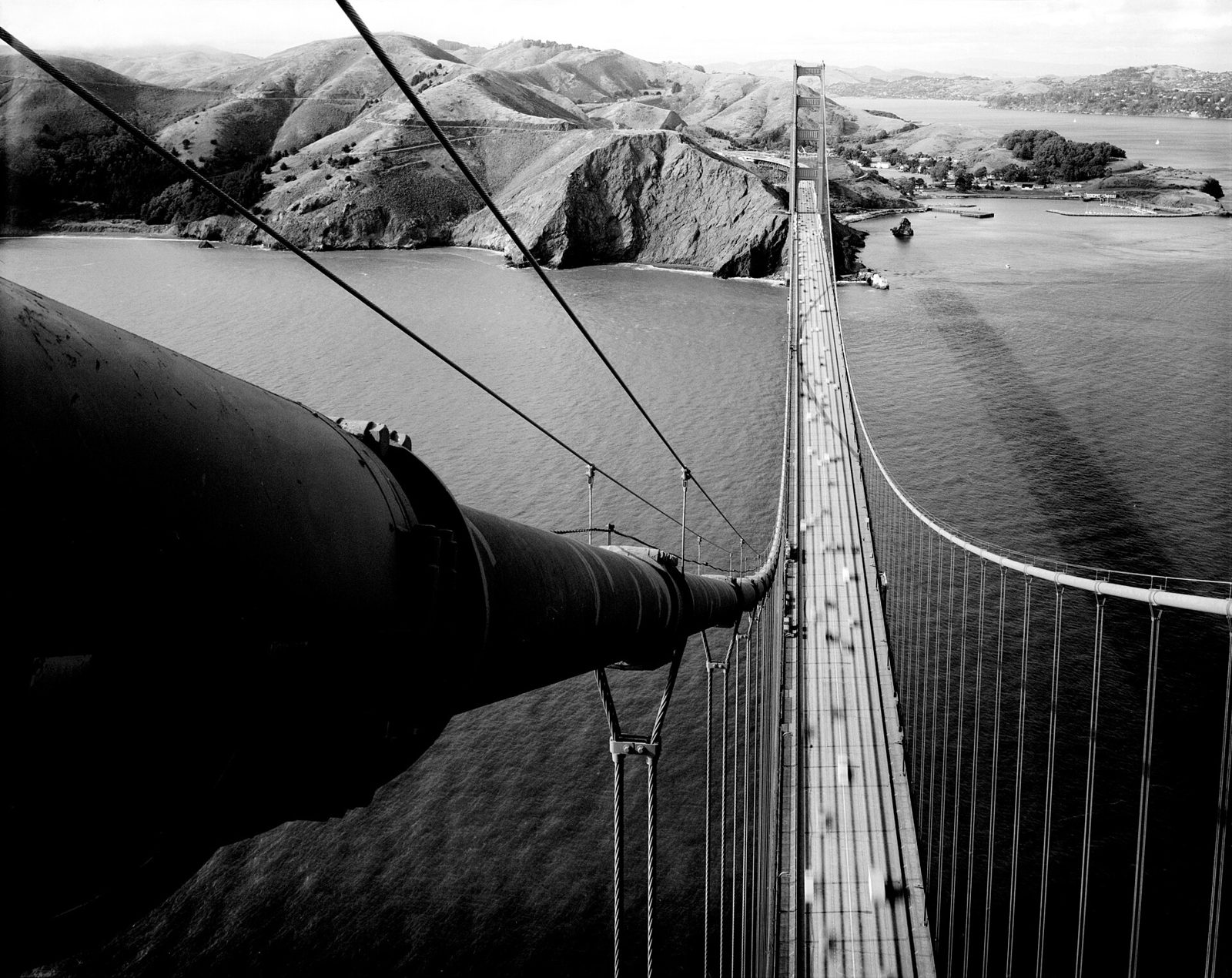 The Marin Headlands seen from the Golden Gate Bridge, bare hills dropping to the water