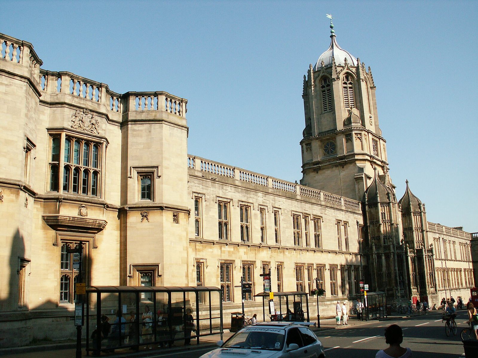 Christ Church college in Oxford seen from St Aldate's, its honey coloured stone frontage and Tom Tower rising above the street