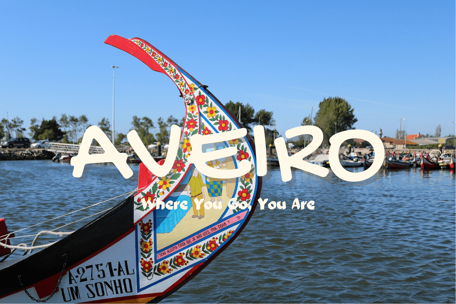 The painted prow of a moliceiro boat on the Aveiro canal, decorated with red and yellow flowers and a folk scene